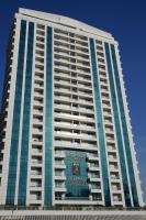 a tall building with a sign on the side of it at Treppan Hotel & Suites By Fakhruddin in Dubai