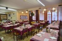een eetkamer met tafels en stoelen met paarse tafelkleden bij HOTEL LA PLAYA in Cervia