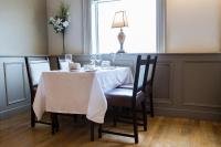a dining room table with a white table cloth at Creighton Hotel in Clones