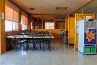 a dining room with a table and chairs and a refrigerator at Hotel Restaurant Casa Miquel in Alcarraz