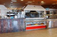 a restaurant kitchen with a counter with a foodcourt at Hotel Restaurant Casa Miquel in Alcarraz