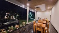 a restaurant with a car parked on the side of a building at Tangkoko Hideaway Cottage in Pulau Mogogimbun