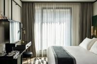 a hotel room with a bed and a window at Academias Hotel, Autograph Collection in Athens