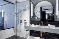 a bathroom with a shower and a sink and a mirror at Academias Hotel, Autograph Collection in Athens