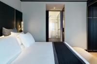 a bedroom with a large white bed and a hallway at Academias Hotel, Autograph Collection in Athens