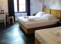 two beds in a hotel room with towels on them at Timeout Heritage Hotel Zagreb in Zagreb