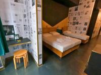 a room with two beds and a table and a stool at Timeout Heritage Hotel Zagreb in Zagreb