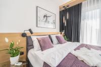 Łóżko lub łóżka w pokoju w obiekcie Apartamenty Fenomen - Premium Porto Nadmorskie Tarasy w Kołobrzegu