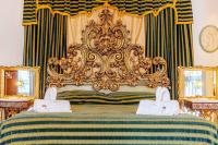 A bed or beds in a room at Palazzo Viola Suite Panoramica Palermo