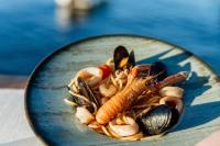a plate of food with shrimp and mussels at San Valentino Palace, Umag city center in Umag