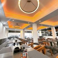 een restaurant met tafels en stoelen en een grote spiegel bij K7 Hotel & Restaurant in Rānchī