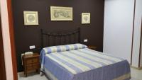Postel nebo postele na pokoji v ubytování Hostal El Lirio