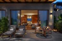 a patio with a table and chairs and a living room at Mandarin Oriental, Bodrum in Golturkbuku