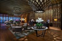 a lobby of a hotel with tables and chairs at Mandarin Oriental, Bodrum in Golturkbuku