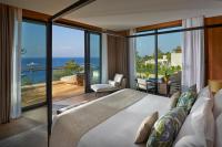a bedroom with a large bed and a view of the ocean at Mandarin Oriental, Bodrum in Golturkbuku