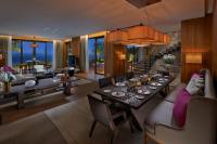 a living room with a table and a dining room at Mandarin Oriental, Bodrum in Golturkbuku