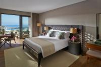 a hotel room with a large bed and a desk at Mandarin Oriental, Bodrum in Golturkbuku