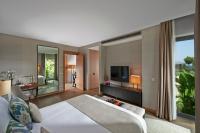 a hotel room with a bed and a television at Mandarin Oriental, Bodrum in Golturkbuku