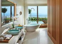 a bathroom with two sinks and a tub with a view at Mandarin Oriental, Bodrum in Golturkbuku