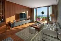 a living room with a couch and a tv at Mandarin Oriental, Bodrum in Golturkbuku