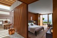 a bedroom with a bed and a desk at Mandarin Oriental, Bodrum in Golturkbuku
