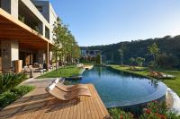 a swimming pool in a building with chairs next to it at Mandarin Oriental, Bodrum in Golturkbuku