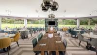 a dining room with tables and chairs at Holiday Inn York by IHG in York