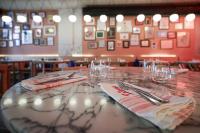 a table in a restaurant with plates and forks and napkins at Look Living, Lisbon Design Apartments in Lisbon