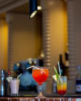 two cocktails sitting on a bar with at Lancaster Kumasi City in Kumasi