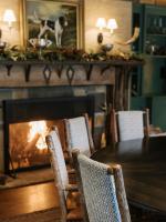 a dining room with a fireplace with a table and chairs at RT Lodge in Maryville