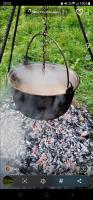 a metal bowl is hanging over a camp fire at ANK -HOME i PRESIDENT- NIK in Telcişor