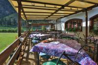 a group of tables and chairs under a pergola at Albergo Boule de Neige in Rhêmes-Notre-Dame