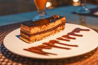 a piece of cake on a plate on a table at Sultan Pyramids Boutique Hotel View in ‘Ezbet `Abd el-Ḥamîd