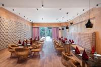 a dining room with wooden tables and chairs at Kufri Heritage Resort & Spa in Kūfrī