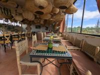 a dining room with tables and chairs and windows at the old house in Marrakech