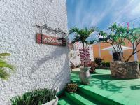 a sign on the side of a building with plants at Hotel Don Luis in Valladolid