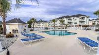 einen Pool mit Liegestühlen in einem Resort in der Unterkunft Beautiful 1500 s f 3 Bd - 2 Ba condo overlooking stream and golf course in Myrtle Beach