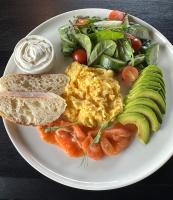 a plate of breakfast food with eggs and a salad at BE THE ONE Hotel in Kyiv