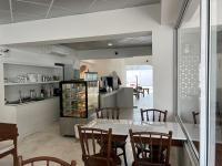 a kitchen and dining room with a table and chairs at VELA Korat Hotel & Cafe' in Nakhon Ratchasima