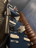 a table with a blue table cloth and a leather seat at The Old Mill Inn in Bedford