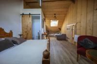 a bedroom with a large bed and wooden walls at Yourtes Olachat proche Annecy in Faverges