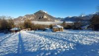 a snow covered field with a mountain in the background at Yourtes Olachat proche Annecy in Faverges