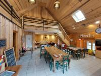 a room with tables and chairs in a restaurant at Yourtes Olachat proche Annecy in Faverges