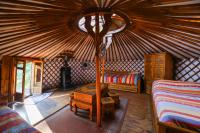 a room with a bed and a table in a yurt at Yourtes Olachat proche Annecy in Faverges