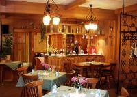 a restaurant with tables and chairs and a bar at Hotel Gasthof zum Walfisch in Klingenthal