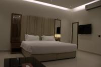 سمت ان النرجس للشقق المخدومة - Samt Inn Al Narjis Serviced Apartmentsにあるベッド