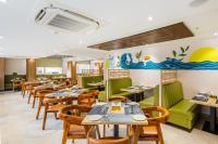 a dining room with tables and chairs at Lemonridge Hotels KPHB in Hyderabad