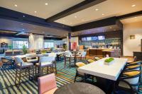 a restaurant with tables and chairs and a bar at Courtyard by Marriott Oahu North Shore in Laie