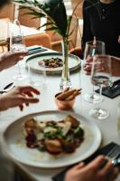 a group of people sitting at a table with a plate of food at Laguna Beskidów Resort - Apartament A31 in Zarzecze