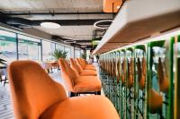 a row of orange chairs in a train car at Laguna Beskidów Resort - Apartament A31 in Zarzecze